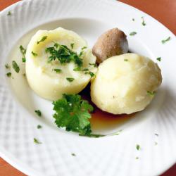 Bayrische Schmankerl: Knusprige Brezenknödel mit feiner Kräutersoße – Eine himmlische Gaumenfreude!